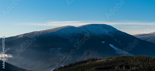 Smrk with lower Maly Smrk hill in winter Moravskoslezske Beskydy mountains in Czech republic photo