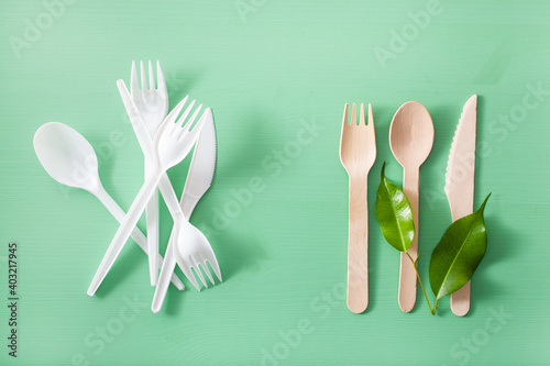 harmful plastic cutlery and eco friendly wooden cutlery. plastic free concept photo