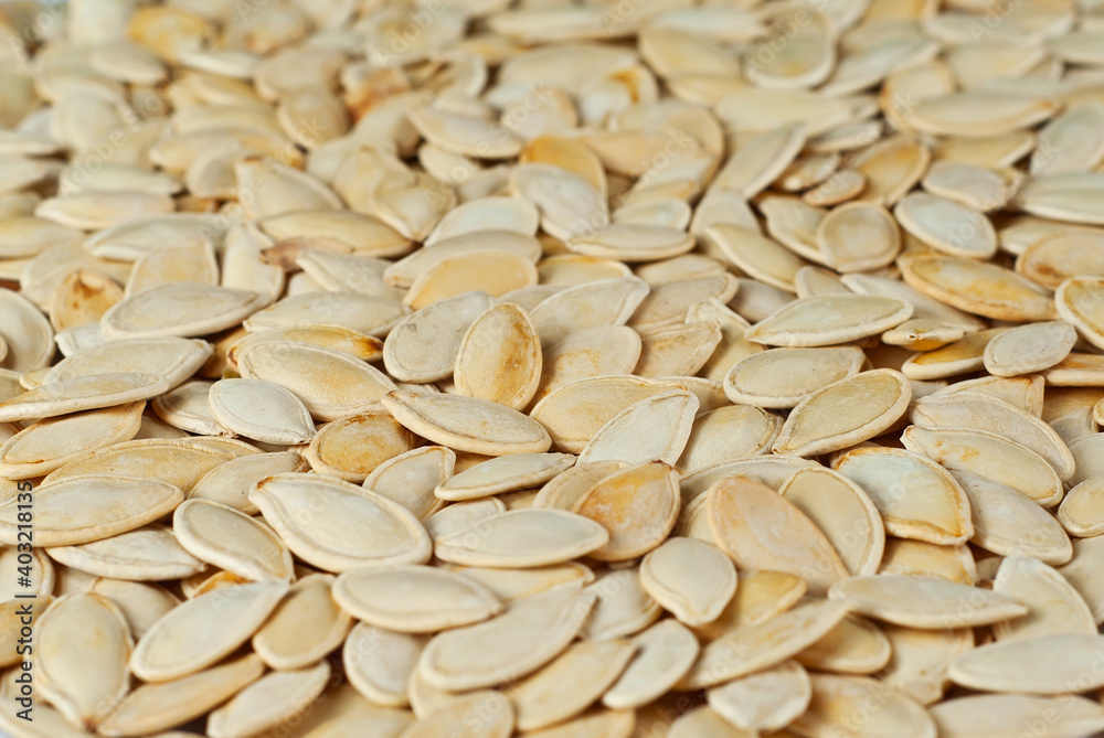 Pumpkin seeds close up. Texture of nuts. Lots of nuts in a pile. Pumpkin seeds close up. Texture of nuts. Lots of nuts in a pile.