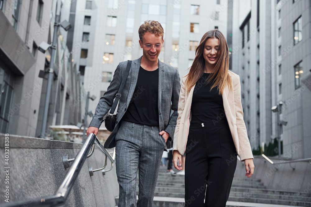 Woman and man in the town at daytime. Well dressed people