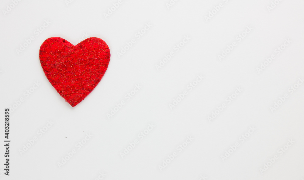 Red heart on a white background. Festive background. Minimalism. Copy space. St. Valentine's Day background