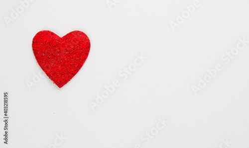 Red heart on a white background. Festive background. Minimalism. Copy space. St. Valentine's Day background