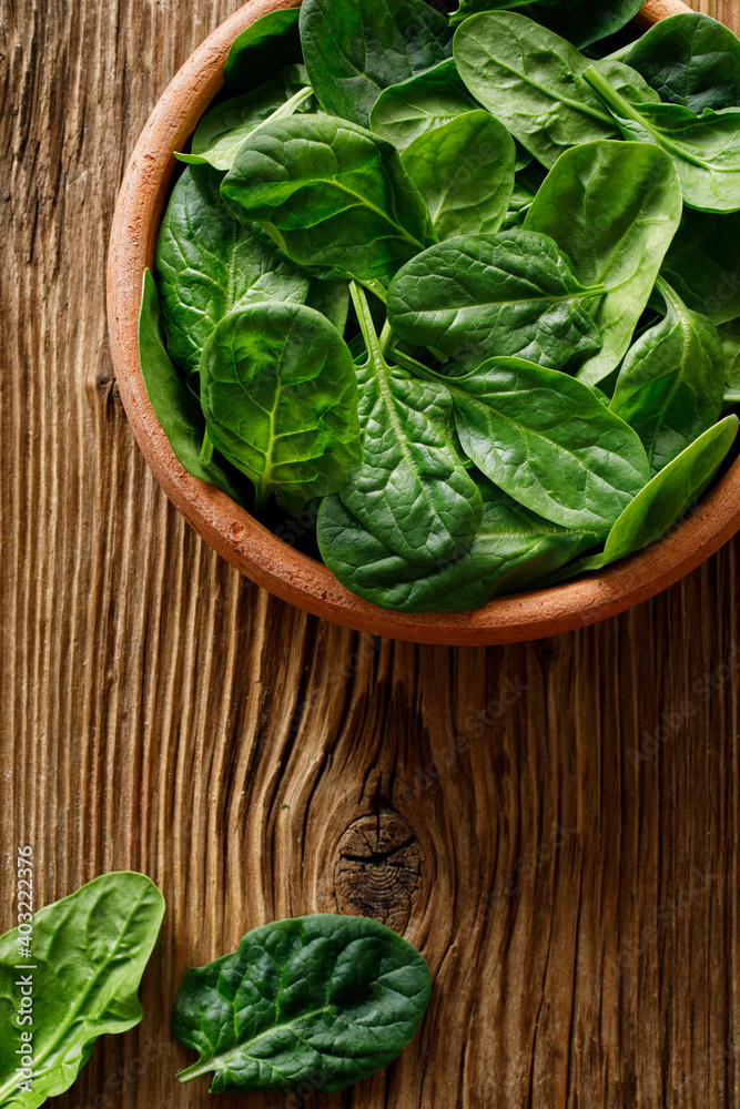 Fresh spinach leaves on wooden background, top view Fresh spinach leaves on wooden background, top view