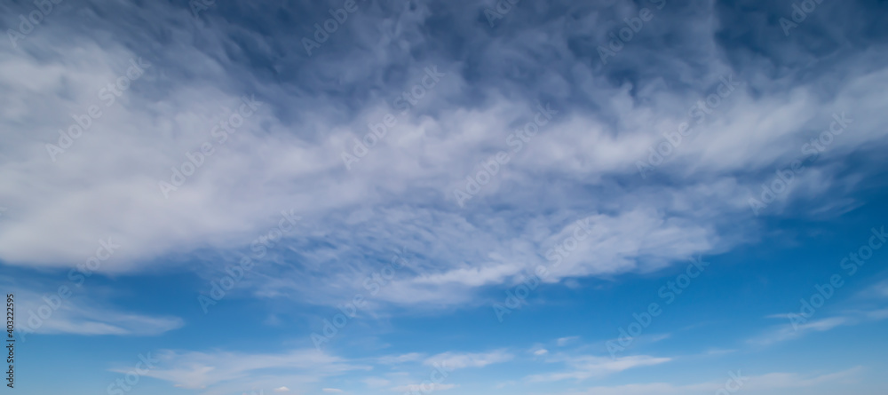 Stunning view of a blue sky with white fluffy clouds during a sunny day. Natural background, wallpaper or preset with copy space.