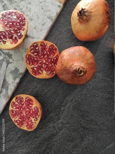 Sliced pomegranates on a marble chopping board