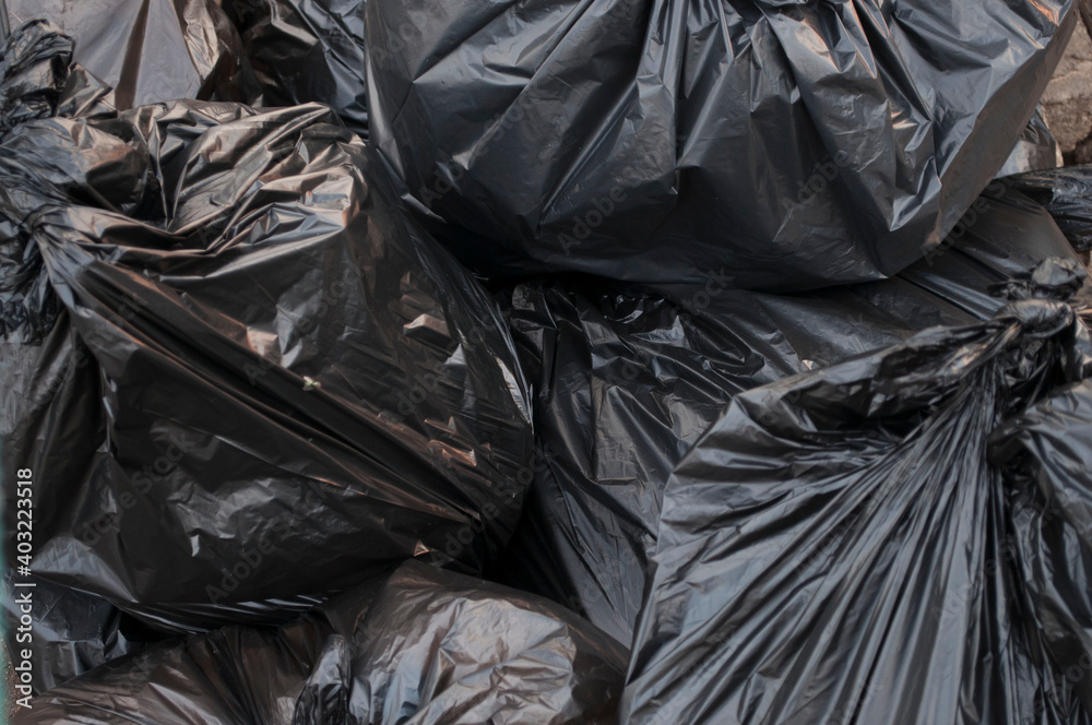 Black garbage bags stacked together