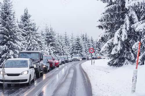 Traffic jam on a slippery road in a beautiful forest landscape