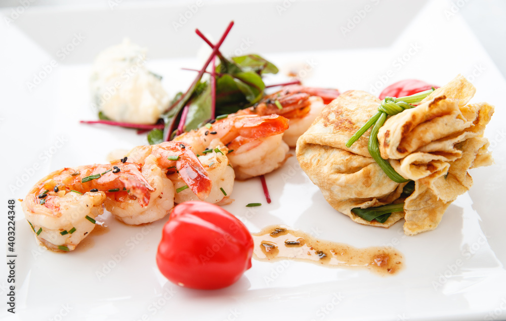 Grilled prawns and fried egg with baby spinach and tomato Grilled prawns and fried egg with baby spinach and tomato