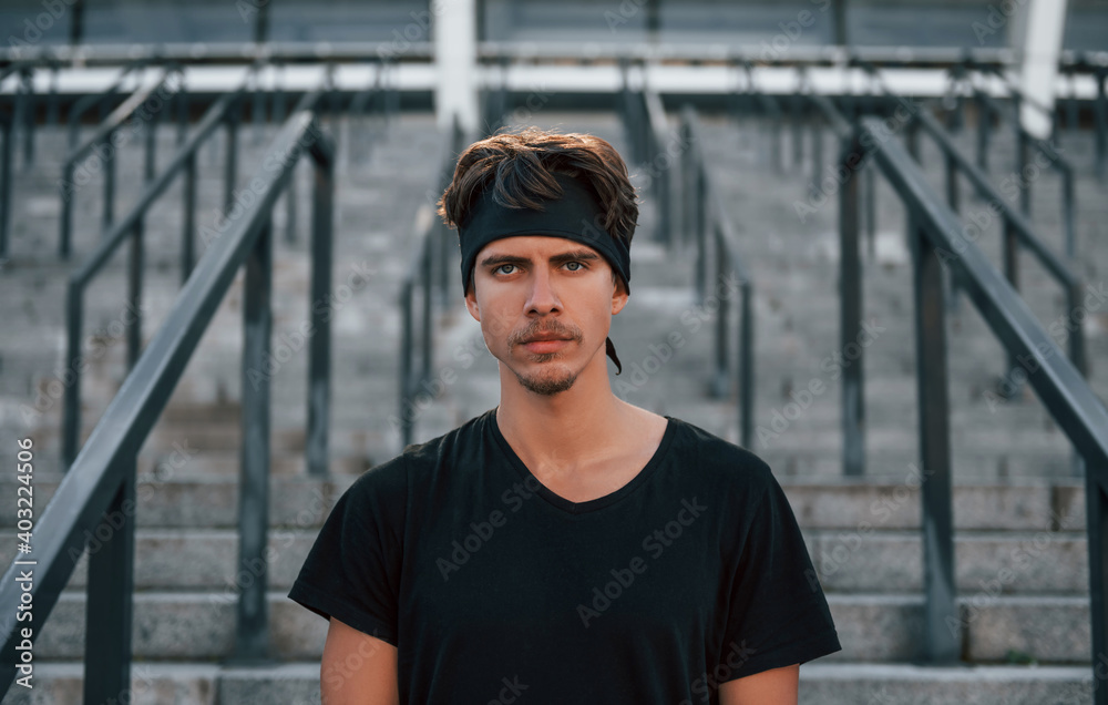 Portrait of young man in sportive clothes that have workout outdoors at daytime