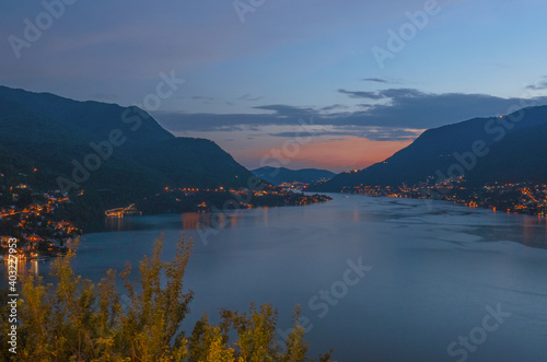 Illuminated villages along the shores of the Como lake at sunset.Lombardy, Italian Lakes, Italy