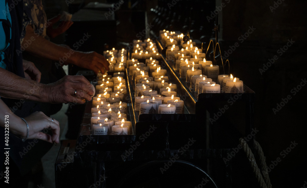 People lighting up candles in memory of deceased dead memorial