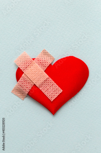 Broken heart patched with a patch. Healing love concept
