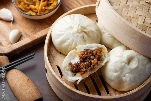 Chinese breakfast. Steamed buns and porridge are on the table photo