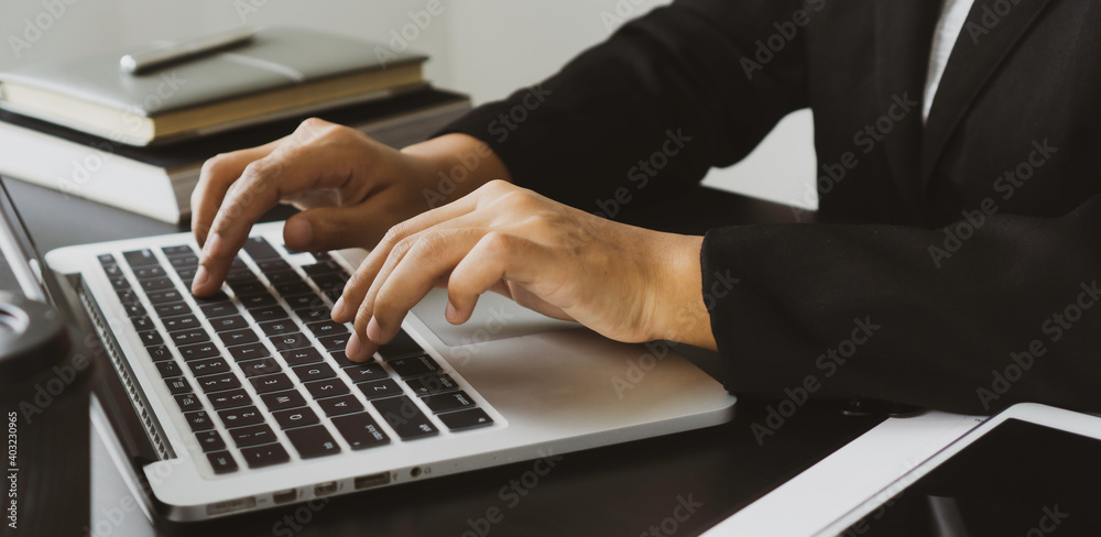 close up of a woman hand typing on the keyboard at home office typing for check electronic mail to prepare the meeting business. close up of a woman hand typing on the keyboard at home office typing for check electronic mail to prepare the meeting business.
