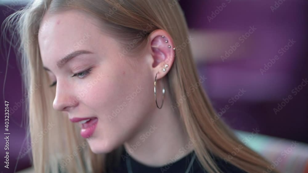 A lonely young blonde woman sitting in the cafeteria waiting, feeling abandoned, cheated and looking very upset. A lonely young blonde woman sitting in the cafeteria waiting, feeling abandoned, cheated and looking very upset.