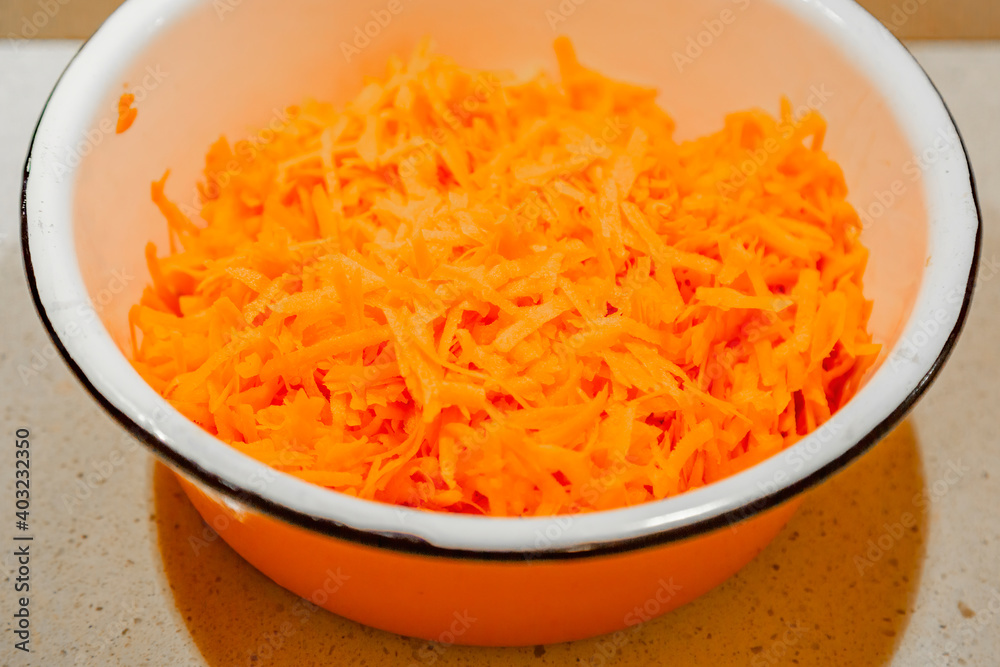 Orange textured surface of freshly grated carrots for a variety of healthy dishes Orange textured surface of freshly grated carrots for a variety of healthy dishes