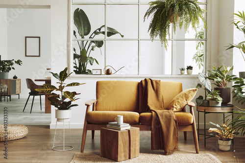 Interior design of scandinavian open space with yellow velvet sofa  plants  furniture  book  wooden cube and personal accessories in stylish home staging. Template.