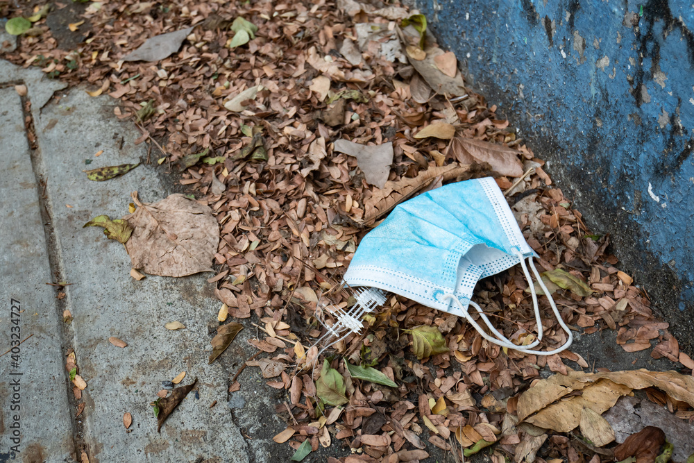 Fototapeta premium Used face mask discarded on the street