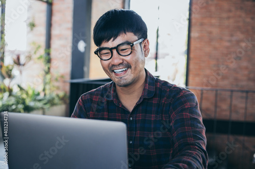happy man work using computer hand typing laptop contact us online chatting search form internet sitting at office.concept for technology device communication business people