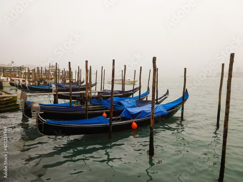 Gondolas in Venice on a misty December morning © Julie