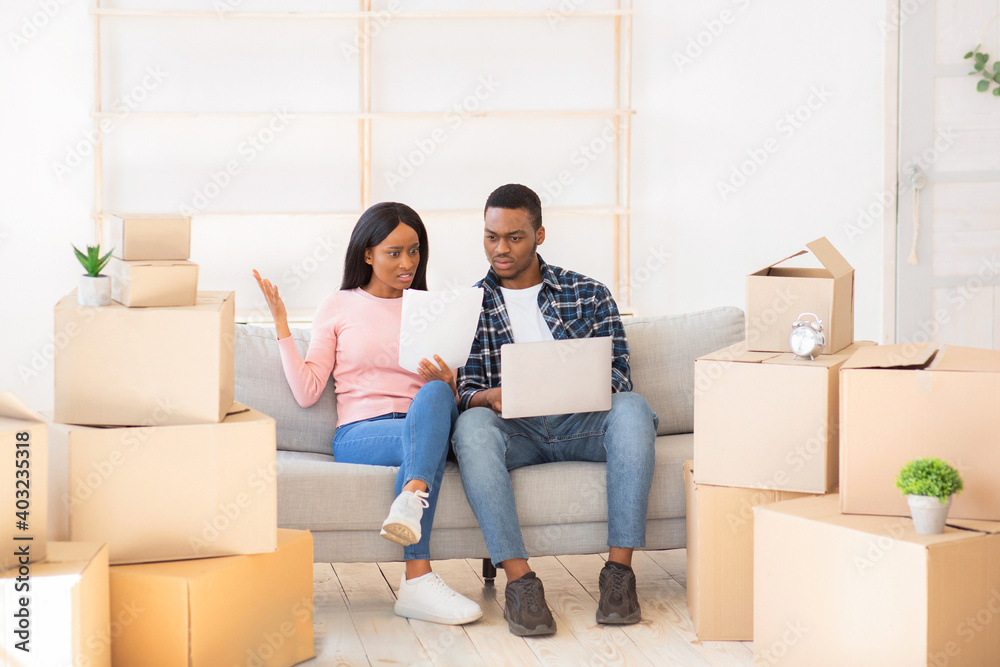 Angry couple with laptop having problem with house ownership documents, sending online complaint to real estate agency Angry couple with laptop having problem with house ownership documents, sending online complaint to real estate agency