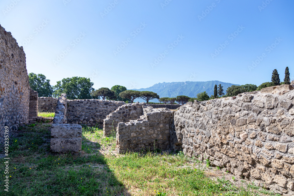 The ruins of the ancient city of Pompeii against the background of the blue Italian sky.
