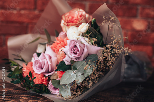 Big mix bouquet of different flowers on wooden background photo