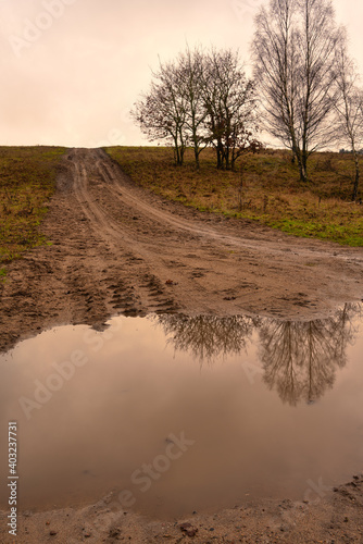 A muddy puddle and a dirt road at a moor. Picture from Revingehed  Scania county  Sweden