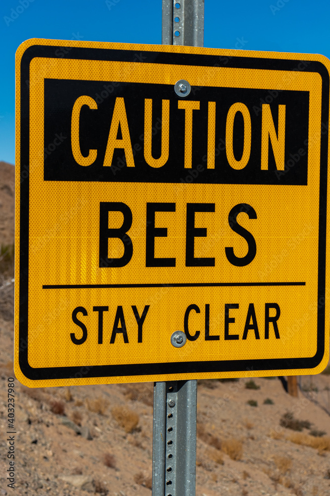 Close up of Caution Bees yellow sign Close up of Caution Bees yellow sign