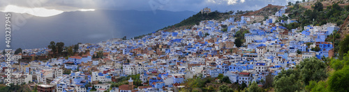 The blue city Chefchaouen / City view of the blue city Chefchaouen with dramatic sky, Morocco, Africa. © ub-foto