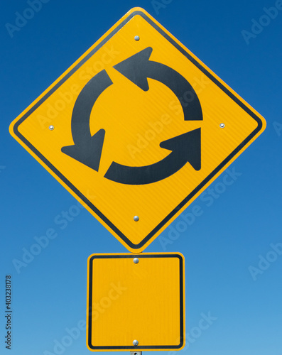 Yellow round about traffic sign with room for copy