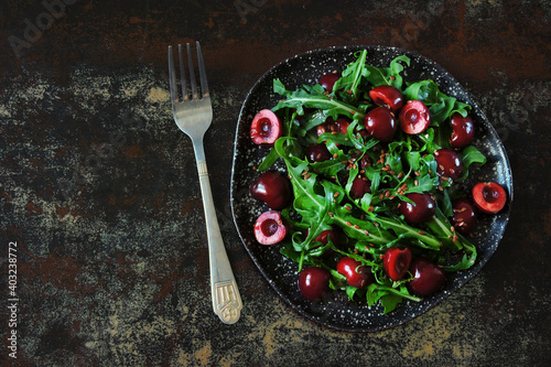 Healthy salad with arugula and cherries. Diet food. Vegan food.