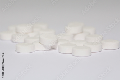 Paracetamol tablets isolated on a white background with selective focus.