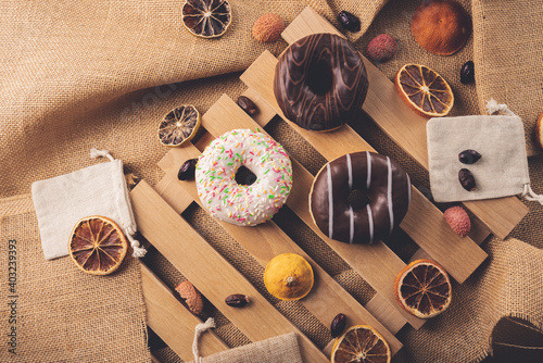 Donuts on wooden and linen background 