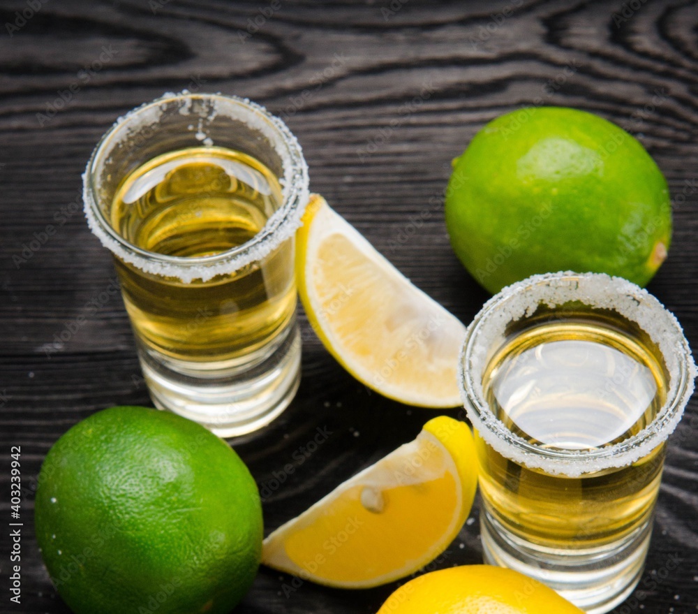 Tequila drink served in glasses with lime and salt Tequila drink served in glasses with lime and salt