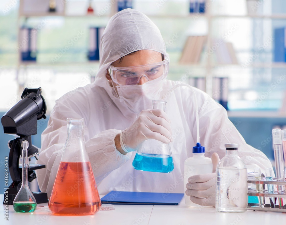 Chemist working in the laboratory with hazardous chemicals Chemist working in the laboratory with hazardous chemicals
