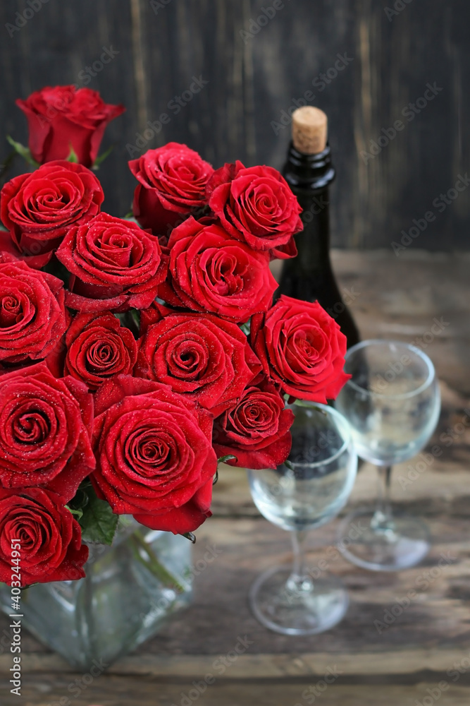 Red roses, wine glasses and bottle wine. beautiful still life with bouquet of roses and wine. love symbol,, Valentine's day, 14 february concept. romantic dinner Red roses, wine glasses and bottle wine. beautiful still life with bouquet of roses and wine. love symbol,, Valentine's day, 14 february concept. romantic dinner