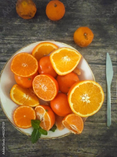 A white plate full of orange slices and tangerines © Saretta_followyourdr
