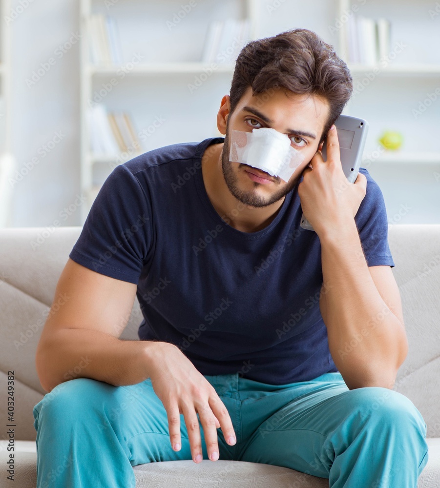 Young man recovering healing at home after plastic surgery nose