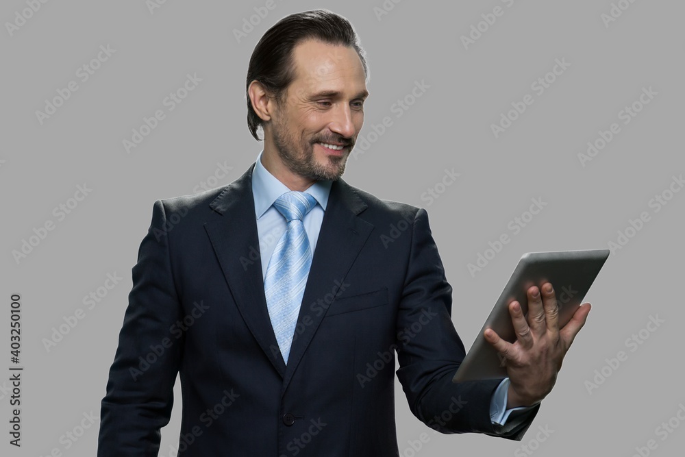 Cheerful businessman having video chat. Smiling caucasian man in business suit happily talking through digital tablet webcam. Cheerful businessman having video chat. Smiling caucasian man in business suit happily talking through digital tablet webcam.