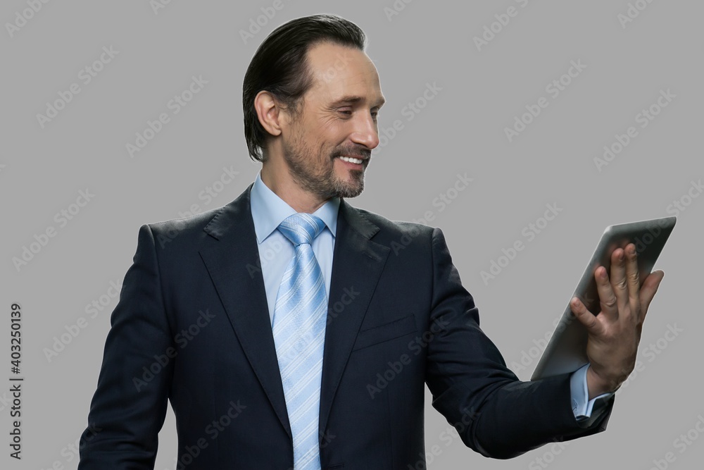 Happy businessman using digital tablet. Smiling caucasian businessman having video chat with family during break. Technology, online communication, internet and people concept. Happy businessman using digital tablet. Smiling caucasian businessman having video chat with family during break. Technology, online communication, internet and people concept.