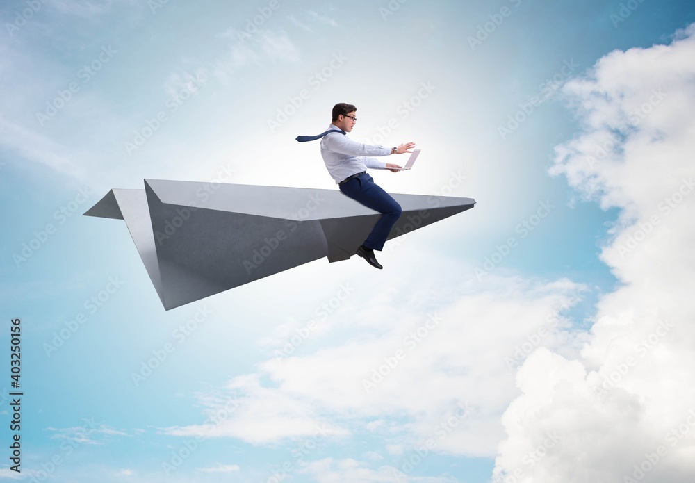 Businessman flying on paper plane in business concept Businessman flying on paper plane in business concept