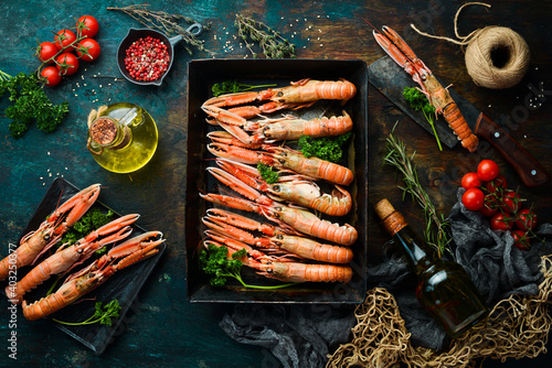 langoustines. raw scampi ready to be cooked in black stone background. Top view. Free copy space.