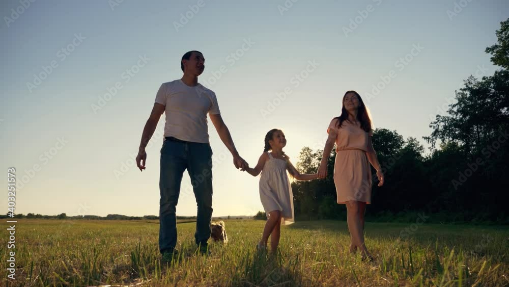 Family walk in lifestyle park. Happy family together in park. family silhouette teamwork child dream concept. Happy child walks with parents. family is enjoying the walk together. Family walk in lifestyle park. Happy family together in park. family silhouette teamwork child dream concept. Happy child walks with parents. family is enjoying the walk together.