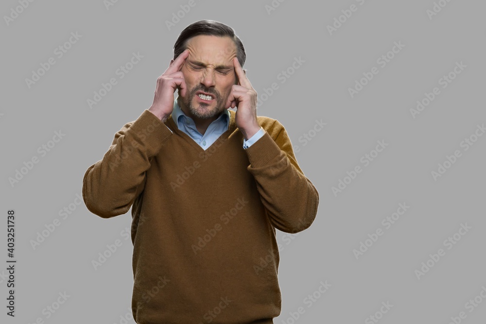 Stressed mature man suffering from headache. Sick man having terrible migraine. Health problem concept. Stressed mature man suffering from headache. Sick man having terrible migraine. Health problem concept.