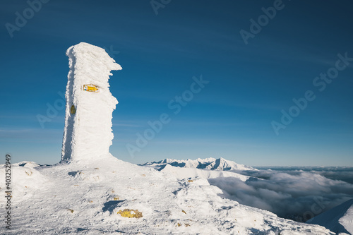 Liptovsky Mikulas, Slovakia - December 31.2020: Frozen Marking Baranec peak of a mountain, the mountain in the Western Tatras in Slovakia. Adventure ascent of alpine peak in snow. photo