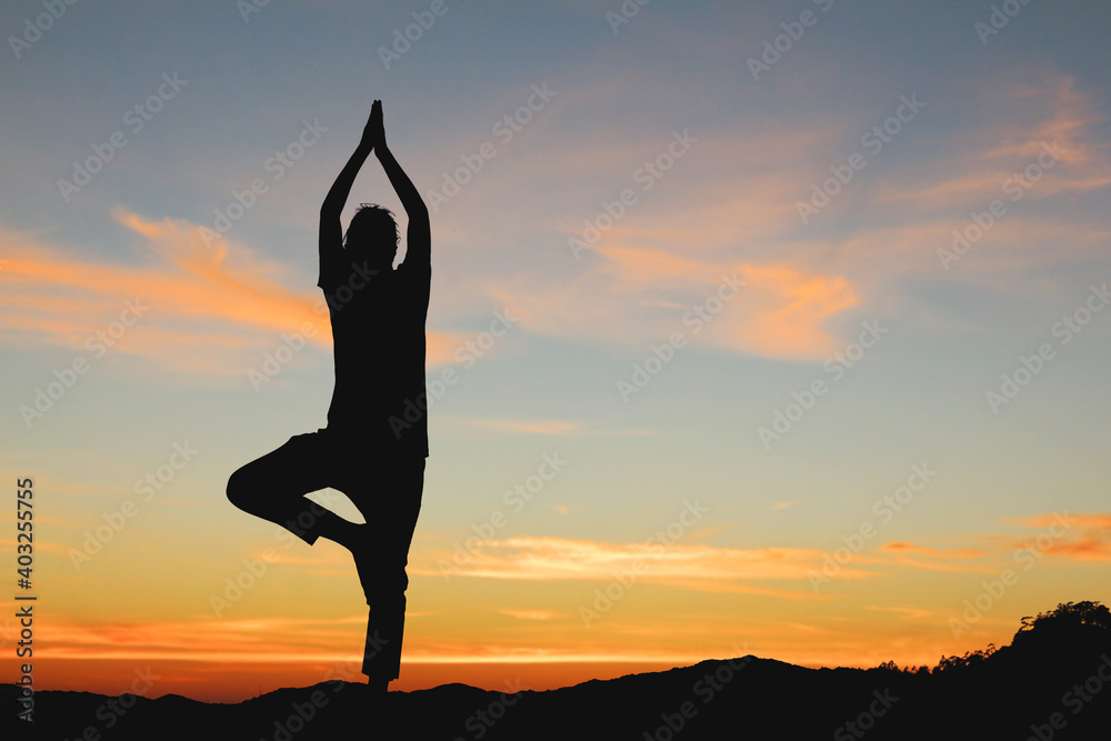 Silhouette of girl doing yoga at sunset.sport for weight loss concepts