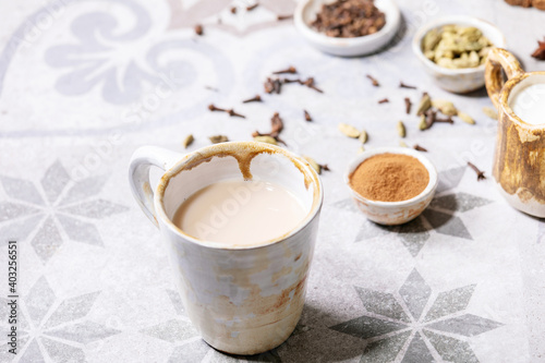 Masala chai served with cinnamon sticks