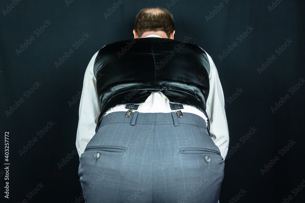 Portrait of Butler or Waiter in Vest Bending Over. Concept of Subservience. Bowing Formally. Buttler. Copy Space for Service Industry