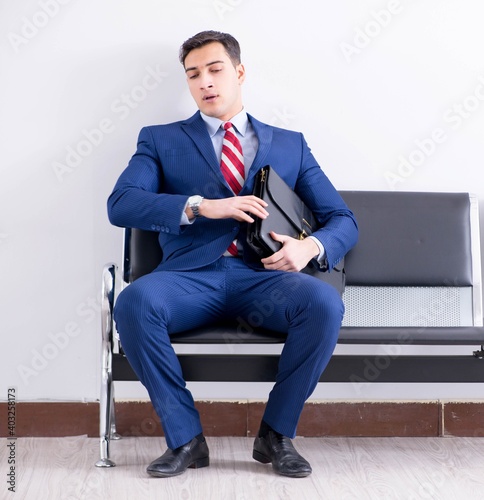 Man wairing to boarding in airport lounge room photo